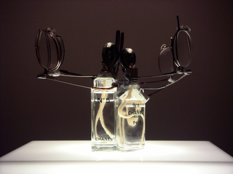 Perfume SOS (No.5 Lamp) 2004. Perfume bottles, eyewear, spoons, cotton wick & melted plastic
